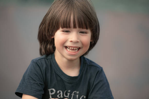 Smiling child face portrait on blurry background stock photo
