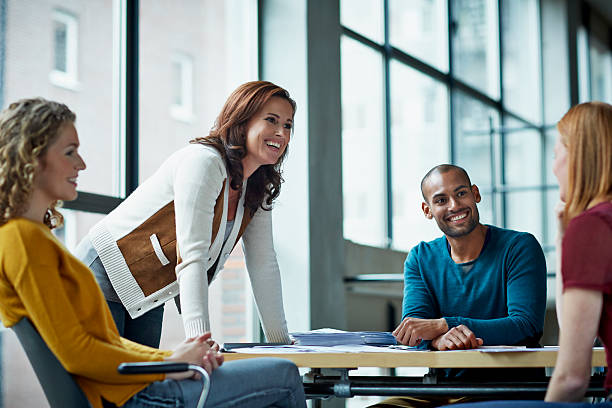 smiling coworkers in meeting - managementconsulent stockfoto's en -beelden
