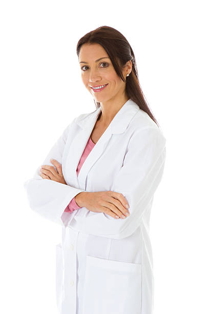 Smiling female wearing labcoat arms crossed stock photo