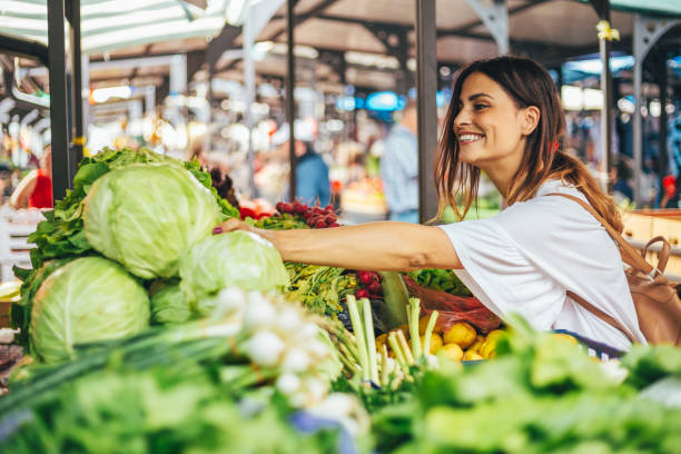 Smiling girl decided to cook a delicious and healthy meal Young cheerful woman at the market cabbage stock pictures, royalty-free photos & images