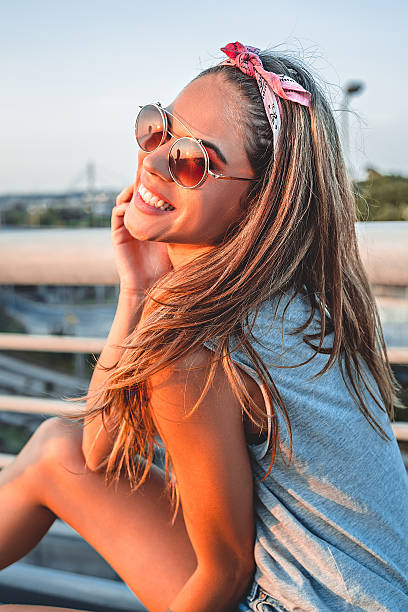 Smiling girl posing on the bridge stock photo