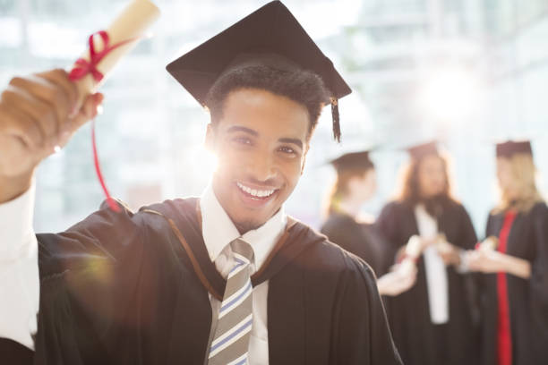 Smiling graduate holding diploma  best schools stock pictures, royalty-free photos & images