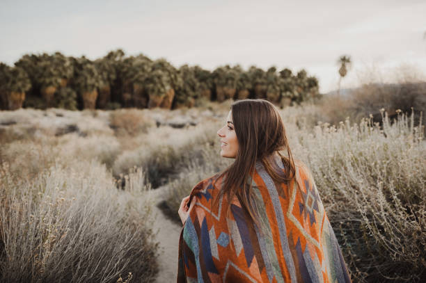 Smiling hipster traveler girl in gypsy look in desert nature Back side of boho woman in the desert nature.  Artistic photo of young hipster traveler girl in gypsy look, vlad model photos stock pictures, royalty-free photos & images
