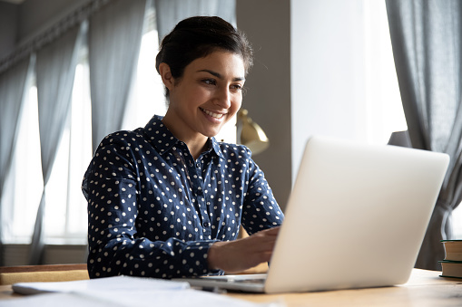 Smiling Indian Girl Student Professional Typing On Laptop At Table Stock  Photo - Download Image Now - iStock