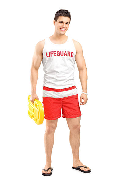 Smiling lifeguard on duty posing Full length portrait of a smiling lifeguard on duty posing isolated on white background lifeguard stock pictures, royalty-free photos & images