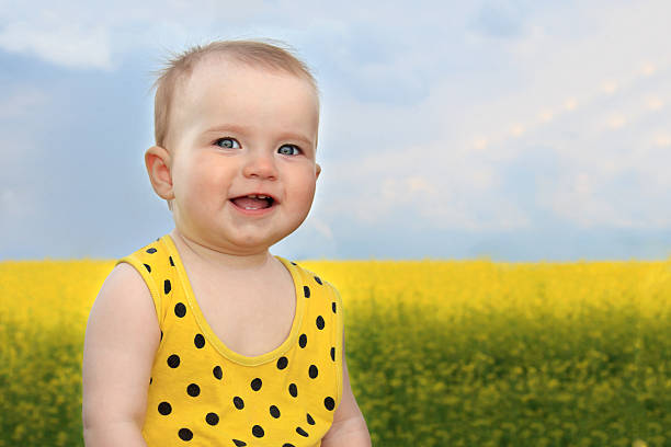 smiling little girl in summer field stock photo