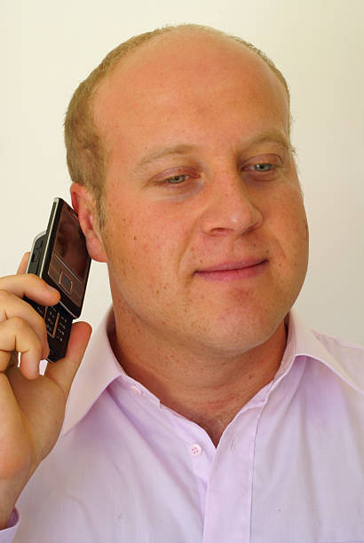 Smiling man with cell phone stock photo