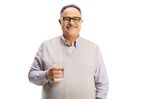 Smiling mature man with glasses holding a glass of water isolated on white background