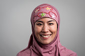 istock Smiling mid adult asian muslim woman looking at the camera 1364106636