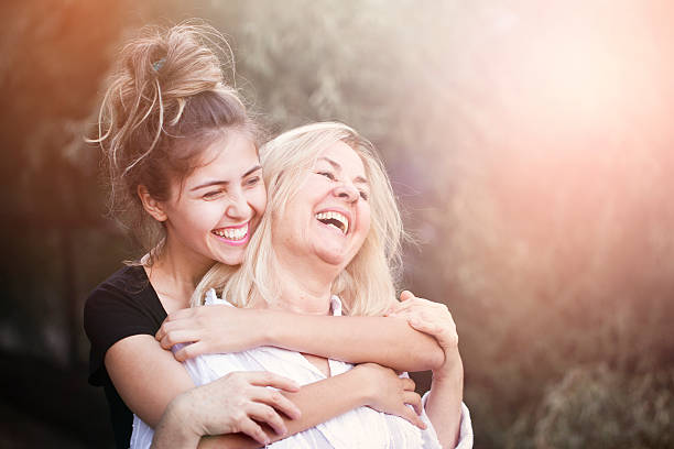 Smiling mother with young daughter stock photo