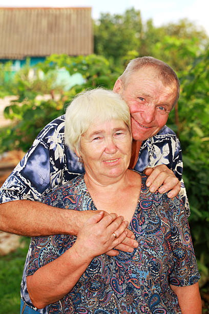 Smiling senior couple embracing outdoors stock photo