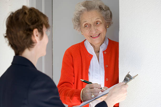Smiling senior woman signing petetion stock photo