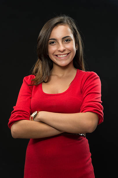 Smiling teenage girl Headshot of a hispanic or middle eastern female college student on black background cute puerto rican girls stock pictures, royalty-free photos & images