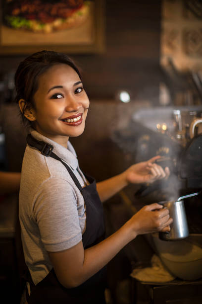 smiling waitress at work brew up coffe smiling waitress at work steam milk , brew up coffee in cafe shop filipino woman stock pictures, royalty-free photos & images
