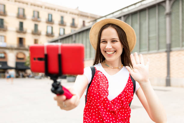 Smiling young woman tourist recording content for her travel vlog. stock photo