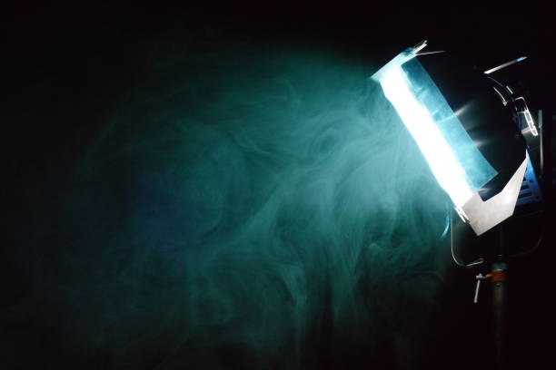 smoke around a filtered light on a film set stock photo