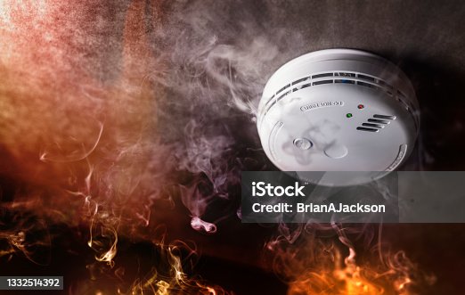 istock Smoke detector and fire alarm in action background 1332514392