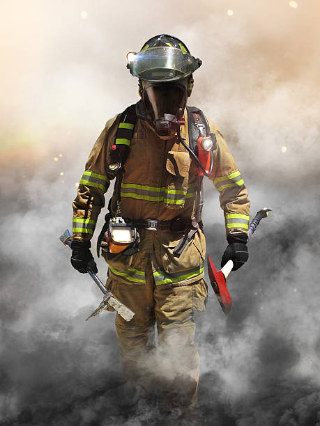 Smoke eater A firefighter pierces through a wall of smoke searching for survivors. firefighters stock pictures, royalty-free photos & images