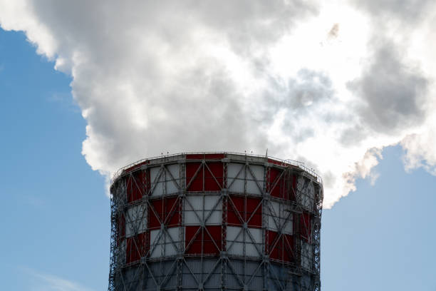 Smoke, emissions from industrial chimney against blue sky background stock photo