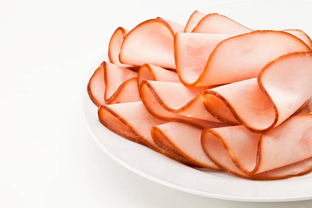 Smoked ham slices on a plate Plate with Slices of Smoked Ham Isolated on White Background.  VISIT MY LIGHTBOX http://i1215.photobucket.com/albums/cc503/carlosgawronski/FoodonWhite.jpg delicatessen photos stock pictures, royalty-free photos & images