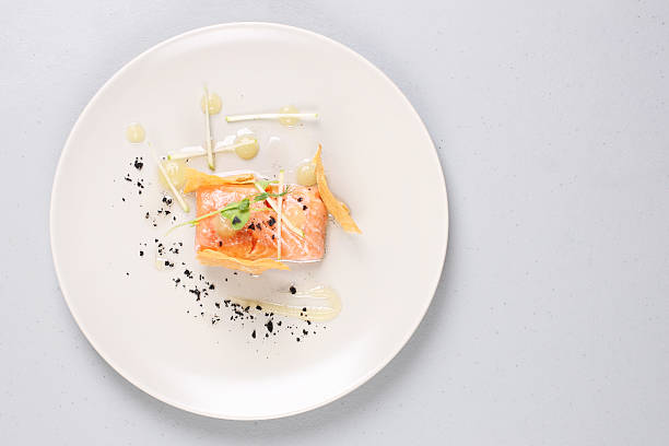 Smoked salmon and sauce cooked by molecular gastronomy technic Smoked salmon with herbs, faked salmon roe. Sauce cooked by molecular gastronomy technic. gourmet stock pictures, royalty-free photos & images