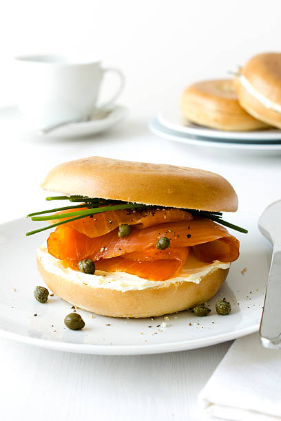 Smoked salmon bagel A smoked salmon bagel with cream cheese and capers, shallow DOF. smoked salmon photos stock pictures, royalty-free photos & images