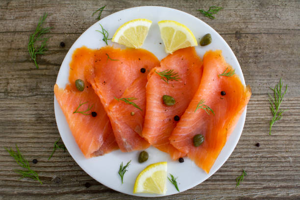 Smoked salmon slices with capers and dill stock photo