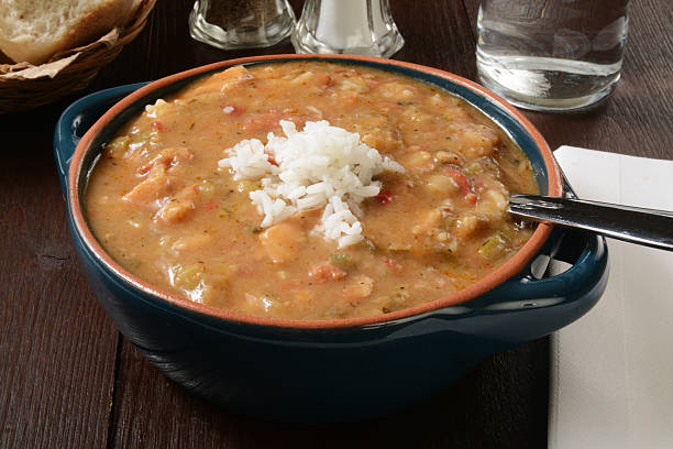 Smoked sausage and chicken gumbo A bowl of smoked sausage and chicken gumbo with white rice gumbo stock pictures, royalty-free photos & images