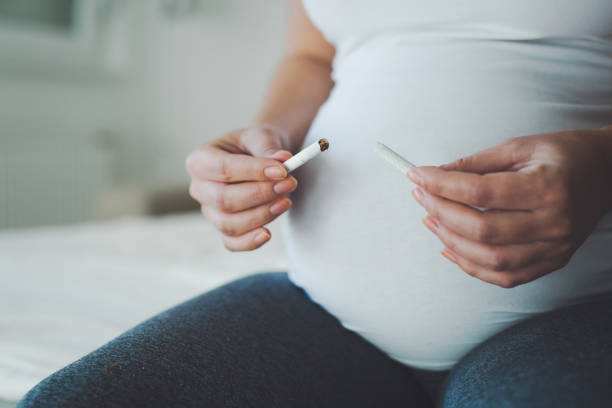Smoking is prohibited during pregnancy as it is dangerous for baby health  little girl smoking cigarette stock pictures, royalty-free photos & images