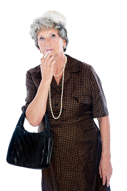 Smoking senior woman Senior woman, 69 years old, with hat and bag. ugly old women stock pictures, royalty-free photos & images