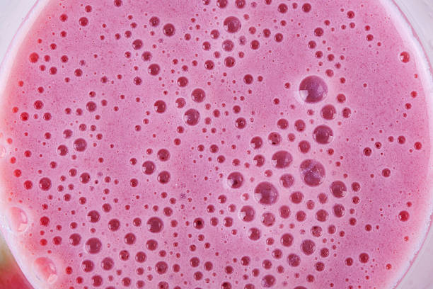 Smoothie froth Close-up of smoothie froth, copy space strawberry smoothie stock pictures, royalty-free photos & images