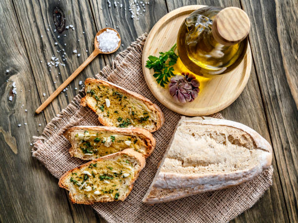 Snack or appetizer of garlic basil and olive oil bruschetta Snack or appetizer of garlic basil and olive oil bruschettas. Garlic bread. garlic bread stock pictures, royalty-free photos & images