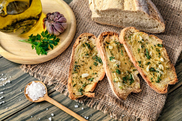 Snack or appetizer of garlic basil and olive oil bruschettas Snack or appetizer of garlic basil and olive oil bruschettas. Garlic bread. garlic bread stock pictures, royalty-free photos & images