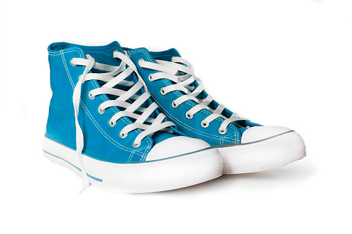 Pair of new blue sneakers isolated on white background.