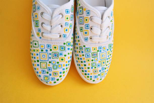 sneakers with hand-painted geometric shapes stock photo