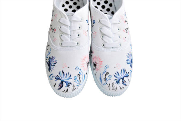 sneakers with hand-painted wild flowers isolated stock photo