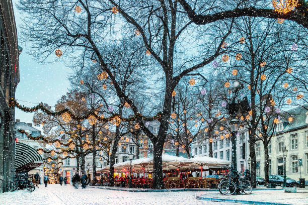 Snow and christmas lights on the Onze Lieve Vrouweplein square in Maastricht stock photo