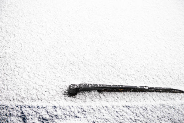 Snow background on window of a car wiper stock photo
