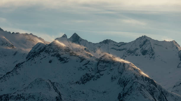 snow banner on alpine ridges stock photo