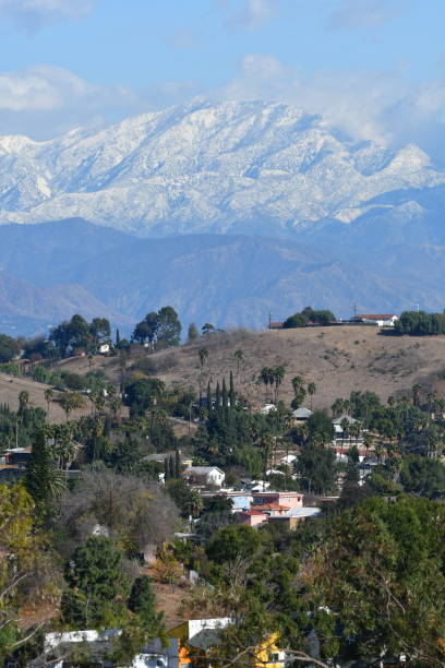 Snow Covered Mountain in Los Angeles with Homes in Foreground Winter Day in Southern California steven harrie stock pictures, royalty-free photos & images