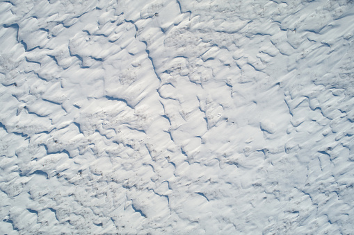 Snow field texture background aerial above drone view