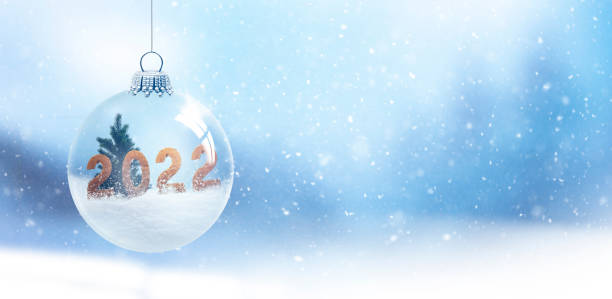 Snow globe with digits 2022 against a blurred background stock photo