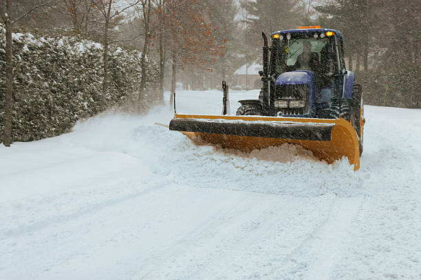 Snow plow tractor stock photo