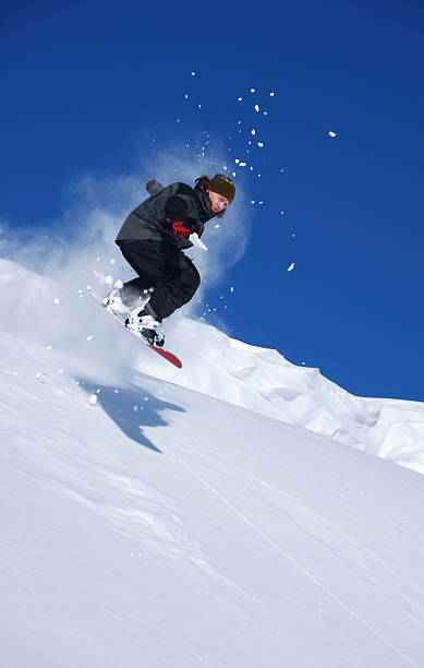 Snowboarder jumping high stock photo