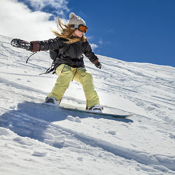 Snowboarder moving down stock photo