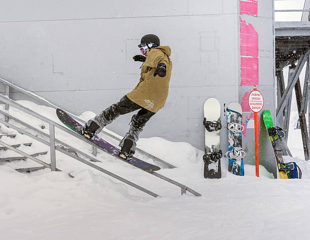 Snowboarder on railing stock photo