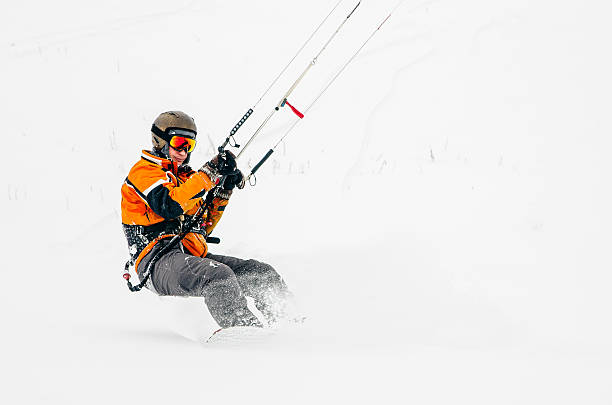 Snowboarder riding a kite stock photo