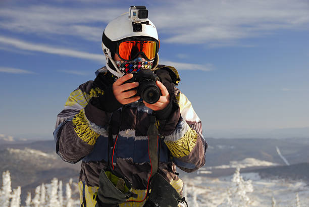 Snowboarder with camera stock photo