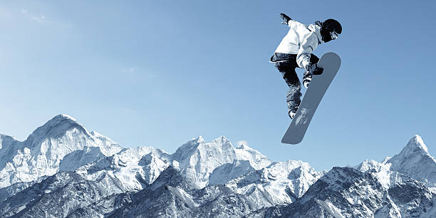 Snowboarding sport Snowboarder making high jump in clear blue sky boarding stock pictures, royalty-free photos & images