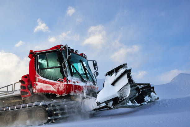snowcat rides to work in the evening stock photo
